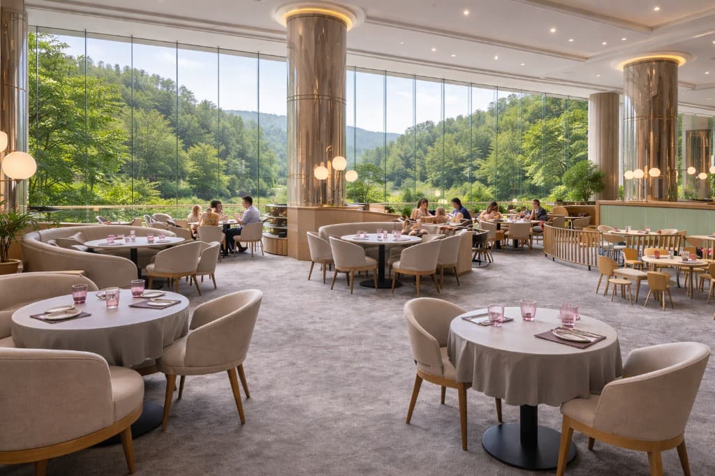 Bright hospitality dining room with large windows and calm seating