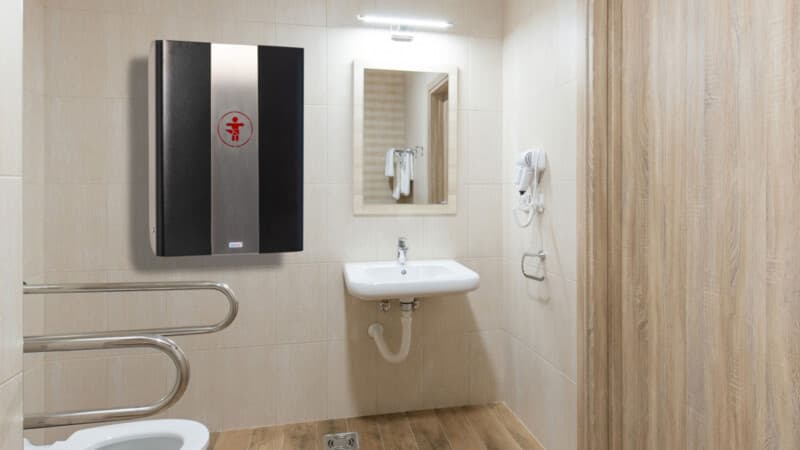 Midi-format wall-mounted changing station in a calm commercial restroom
